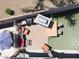 Backyard featuring artificial grass, outdoor kitchen, gas fire pit, patio, and dining space at 16511 W Cortez St, Surprise, AZ 85388