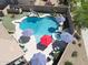 Aerial view showcases a private backyard oasis with pool, spa, slide, and ample seating at 16511 W Cortez St, Surprise, AZ 85388