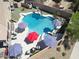 Drone view displays backyard oasis featuring pool, slide, waterfall, spa, and lounge seating at 16511 W Cortez St, Surprise, AZ 85388