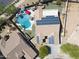 Drone image displays backyard with solar panels, pool, spa, patio, and manicured landscaping at 16511 W Cortez St, Surprise, AZ 85388