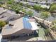 Aerial view of home with solar panels, fenced yard, pool, and desert landscaping at 16511 W Cortez St, Surprise, AZ 85388