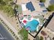 Aerial view of a home with solar panels, a private pool, outdoor kitchen, and landscaped backyard at 16511 W Cortez St, Surprise, AZ 85388