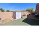 Fenced backyard with low maintenance landscaping, including an outdoor storage shed and ample space at 16511 W Cortez St, Surprise, AZ 85388