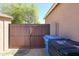 A metal gate and trash bins are seen in the backyard at 16511 W Cortez St, Surprise, AZ 85388