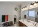 Bright bathroom featuring double sinks, a large mirror, and a separate tub at 16511 W Cortez St, Surprise, AZ 85388