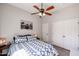Bedroom with wood floors, a ceiling fan and an art piece decorating the wall at 16511 W Cortez St, Surprise, AZ 85388