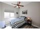 Bright bedroom with wood floors, a ceiling fan and an art piece decorating the wall at 16511 W Cortez St, Surprise, AZ 85388
