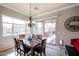 Dining room features a modern chandelier and view of the pool at 16511 W Cortez St, Surprise, AZ 85388
