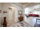 Bright hallway leading into a living area with wood-look floors and modern accents at 16511 W Cortez St, Surprise, AZ 85388