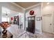 Neutral hallway view with a coat rack, mirror, and a view of a stylish living area at 16511 W Cortez St, Surprise, AZ 85388