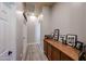 Hallway with white trim, wood floors and built-in cabinet adorned with Gathering photos at 16511 W Cortez St, Surprise, AZ 85388