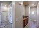 Hallway with white doors, neutral walls, wood floors and built-in cabinet for storage at 16511 W Cortez St, Surprise, AZ 85388