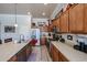 Updated kitchen featuring stainless appliances, light countertops, and ample cabinet space at 16511 W Cortez St, Surprise, AZ 85388