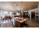 Open concept kitchen with island seating flows into dining and living areas at 16511 W Cortez St, Surprise, AZ 85388