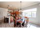 Open kitchen and dining area featuring wood cabinets, an island and a view of the outdoor pool at 16511 W Cortez St, Surprise, AZ 85388