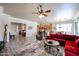 Open living area features a cozy red sofa, modern decor, and wood-look flooring at 16511 W Cortez St, Surprise, AZ 85388