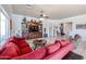 Spacious living room with a large red sofa, decorative rug and wood entertainment center at 16511 W Cortez St, Surprise, AZ 85388
