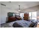 Spacious main bedroom features a ceiling fan, desk area, dresser, and natural lighting at 16511 W Cortez St, Surprise, AZ 85388