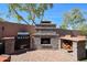 Outdoor kitchen and fireplace with grill and wood storage, perfect for alfresco dining and entertainment at 16511 W Cortez St, Surprise, AZ 85388