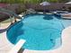 Close up of a sparkling private backyard pool with a slide, diving board, and jacuzzi at 16511 W Cortez St, Surprise, AZ 85388