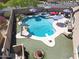 Aerial view of a private backyard pool with a slide, diving board, jacuzzi, and lounge area at 16511 W Cortez St, Surprise, AZ 85388