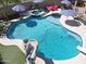 Beautiful pool with spa, slide, and diving board in a backyard is perfect for relaxation and recreation at 16511 W Cortez St, Surprise, AZ 85388