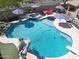 Aerial view of a sparkling private backyard pool with a slide, diving board, and jacuzzi at 16511 W Cortez St, Surprise, AZ 85388
