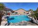 Beautiful backyard pool featuring a rock waterfall and slide, creating a fun and relaxing outdoor space at 16511 W Cortez St, Surprise, AZ 85388