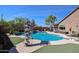 Backyard pool with a slide, diving board, spa, and covered patio seating, perfect for outdoor recreation at 16511 W Cortez St, Surprise, AZ 85388