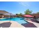 Private backyard pool with water slide, waterfall feature and jacuzzi is surrounded by ample patio space for lounging and entertaining at 16511 W Cortez St, Surprise, AZ 85388