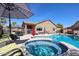 Inviting backyard pool and patio area, perfect for entertaining and relaxation, featuring a jacuzzi and comfortable seating at 16511 W Cortez St, Surprise, AZ 85388