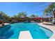 A backyard pool with a slide and diving board, waterfall feature, and jacuzzi is ready for outdoor fun and relaxation at 16511 W Cortez St, Surprise, AZ 85388