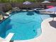 Inviting backyard pool featuring a slide, diving board, spa, and rock waterfall at 16511 W Cortez St, Surprise, AZ 85388