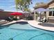 Stunning pool area with seating, grilling area, and lounge space is perfect for entertaining at 16511 W Cortez St, Surprise, AZ 85388
