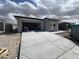Modern single-story home with wide driveway and covered front porch under construction at 17293 W Desert Sage Dr, Goodyear, AZ 85338