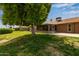 Lush backyard with trees and grass, on golf course at 18211 N Conestoga Dr, Sun City, AZ 85373