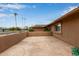 Patio with painted concrete and stucco privacy wall at 18211 N Conestoga Dr, Sun City, AZ 85373