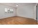 Bright bedroom featuring hardwood floors, plantation shutters, and a ceiling fan at 18211 N Conestoga Dr, Sun City, AZ 85373
