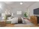 Comfortable bedroom with a ceiling fan, light walls, and a wooden floor at 18211 N Conestoga Dr, Sun City, AZ 85373