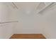 Walk-in closet featuring wood floors and ample storage space at 18211 N Conestoga Dr, Sun City, AZ 85373