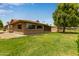 Exterior shot of the house showing backyard and lawn at 18211 N Conestoga Dr, Sun City, AZ 85373