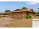Single-story home featuring a desert rock yard, covered porch, and a two-car garage at 18211 N Conestoga Dr, Sun City, AZ 85373