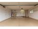 Spacious garage with ample storage cabinets and work area at 18211 N Conestoga Dr, Sun City, AZ 85373