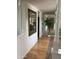 Hallway showcasing hardwood floors and decorative mirror, creating an open and bright space at 18211 N Conestoga Dr, Sun City, AZ 85373