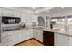 Bright kitchen featuring white cabinets, granite countertops, and stainless steel appliances at 18211 N Conestoga Dr, Sun City, AZ 85373