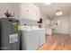 Laundry room featuring a washer, dryer, water heater, and ample storage cabinets at 18211 N Conestoga Dr, Sun City, AZ 85373