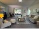 Comfortable living room with plush seating, elegant decor, and sliding glass doors to the outdoor space at 18211 N Conestoga Dr, Sun City, AZ 85373