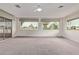 Large living room with neutral carpet, bright windows and natural light at 18211 N Conestoga Dr, Sun City, AZ 85373