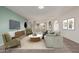 Staged living room featuring an open layout, stylish furniture and natural light at 18211 N Conestoga Dr, Sun City, AZ 85373