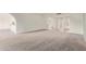 A spacious living room with neutral carpet and white walls at 18211 N Conestoga Dr, Sun City, AZ 85373